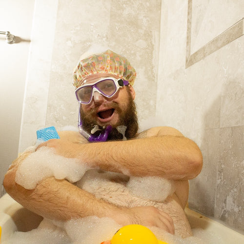 Man enjoys bath with Sud Stud and rubber ducky